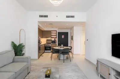 a living room with a couch and a table at High-Rise & Boulevard View - 5-min to Burj & Mall in Dubai