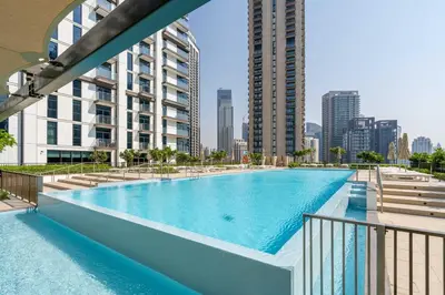 a swimming pool in the middle of a city with buildings at High-Rise & Boulevard View - 5-min to Burj & Mall in Dubai