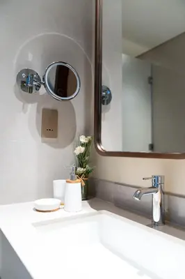 a bathroom with a sink and a mirror at Luxurious 1BR Pool with Burj Khalifa View Dubai Mall in Dubai