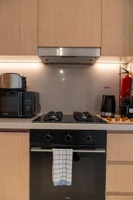 a kitchen with a stove and a microwave at Luxurious 1BR Pool with Burj Khalifa View Dubai Mall in Dubai