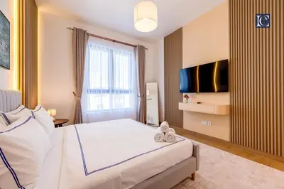a hotel room with a bed and a television at Luxury Escapes - Breathtaking 1BR with Sea View Port Lamer in Dubai