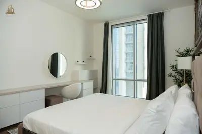 a bedroom with a white bed and a window at Stylish Canal Views Al Habtoor City in Dubai