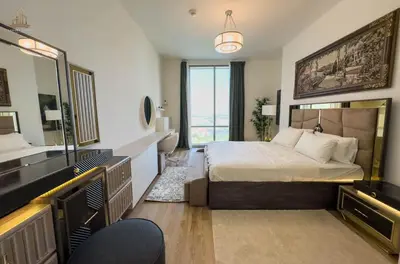 a bedroom with a large bed and a large window at Stylish Canal Views Al Habtoor City in Dubai