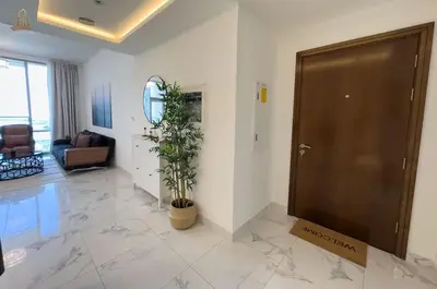 a lobby with a door and a plant in a room at Stylish Canal Views Al Habtoor City in Dubai