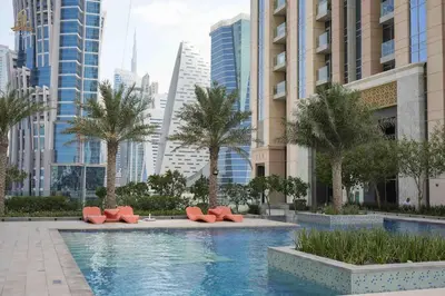 a swimming pool in a city with tall buildings at Stylish Canal Views Al Habtoor City in Dubai