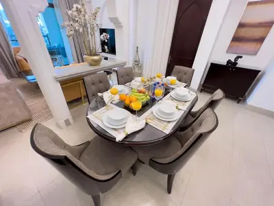 a dining room table with a bowl of fruit on it at Upgraded 2bdr with acess to Dubai Mall in Dubai