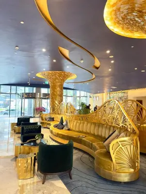 a lobby with a large couch and a large chandelier at Damac Prive in Dubai