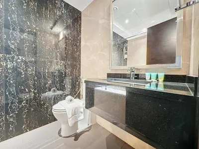 a bathroom with a sink and a toilet in it at Stylish 1BR in Downtown Dubai in Dubai