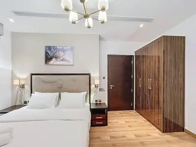 a bedroom with a large bed and a ceiling fan at Stylish 1BR in Downtown Dubai in Dubai