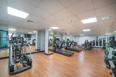 a gym with several treadmills and exercise bikes at EasyGo-Marina Living with View and Amenities in Dubai