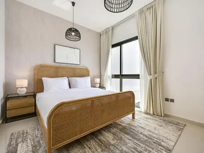 a bedroom with a bed and a large window at 4BR Luxurious Villa DAMAC Hills 2 in Dubai