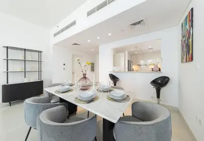 a dining room with a table and chairs at Luxury 3BR Downtown Stay Near Burj in Dubai