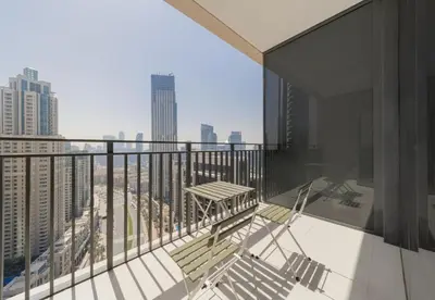 a balcony with a table and chairs on a building at Luxury 3BR Downtown Stay Near Burj in Dubai
