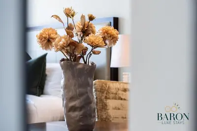 a vase filled with flowers sitting on a table at The Classy in Dubai