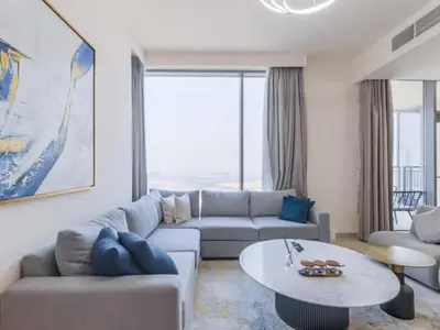 a living room with a couch and a table at TRPS - Creek Rise Tower, Dubai Creek Harbour - 3BR with Marina View in Dubai