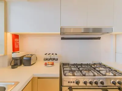 a kitchen with a stove and a sink at TRPS - Creek Rise Tower, Dubai Creek Harbour - 3BR with Marina View in Dubai