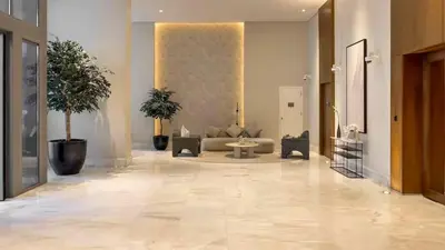 a lobby with a couch and potted plants in a building at TRPS - Creek Rise Tower, Dubai Creek Harbour - 3BR with Marina View in Dubai