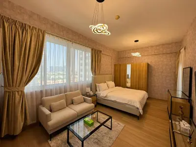 a hotel room with a bed and a couch at Champion Tower 1 Sports city By Al sarya Holiday Homes in Dubai