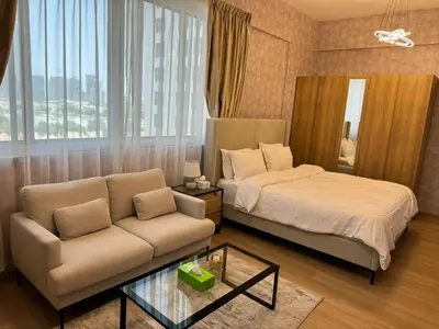 a living room with a bed and a couch at Champion Tower 1 Sports city By Al sarya Holiday Homes in Dubai