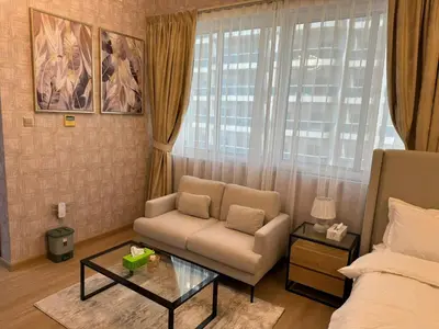 a living room with a couch and a coffee table at Champion Tower 1 Sports city By Al sarya Holiday Homes in Dubai