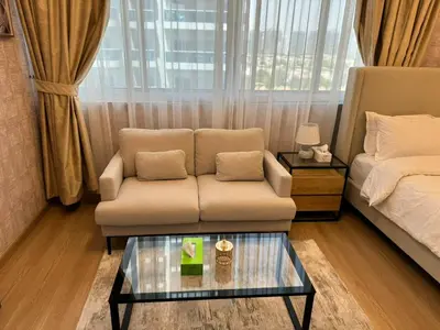 a living room with a couch and a coffee table at Champion Tower 1 Sports city By Al sarya Holiday Homes in Dubai