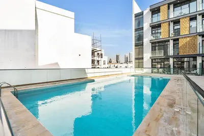 a swimming pool on the side of a building at DAYF-SER03 Brand New Studio with Balcony in JVC in Dubai
