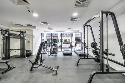 a gym with several treadmills and exercise machines at DAYF-SER03 Brand New Studio with Balcony in JVC in Dubai