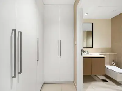 a bathroom with white cabinets and a sink at Prestige stay next to Burj Khalifa in Dubai