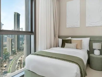 a bedroom with a bed and a large window at Prestige stay next to Burj Khalifa in Dubai