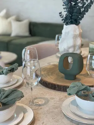 a table with wine glasses and plates on it at Prestige stay next to Burj Khalifa in Dubai
