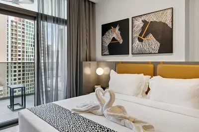 a hotel room with a bed with a swan towel at Luxury Escapes Modern Studio MAG 318 in Dubai