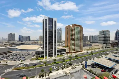 a city skyline with tall buildings and a highway at Luxury Escapes Modern Studio MAG 318 in Dubai