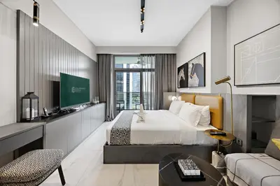 a hotel room with a bed and a couch at Luxury Escapes Modern Studio MAG 318 in Dubai