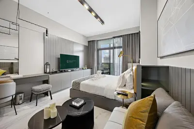 a hotel room with a bed and a tv at Luxury Escapes Modern Studio MAG 318 in Dubai