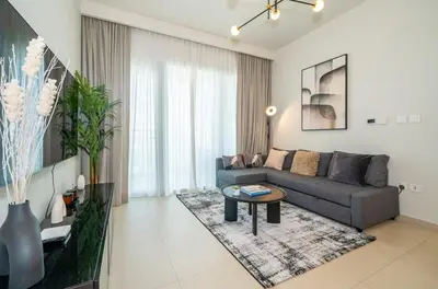 a living room with a couch and a table at Zapbed House -Stylish 1 BR Apartment Downtown Views II Tower 2 in Dubai