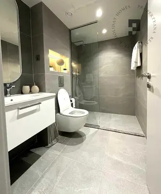 a bathroom with a toilet and a sink and a shower at Cozy 1BR in Burj Views I Top Location Walk to Dubai Mall & Burj Khalifa I Wi-Fi in Dubai