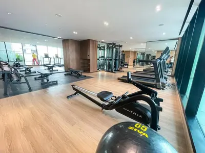 a gym with rows of treadmills and exercise machines at 1bhk brand new in JVC Binghatti Lavender in Dubai