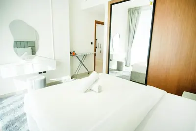 a bedroom with two white beds and a mirror at 1bhk brand new in JVC Binghatti Lavender in Dubai