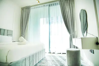 a bedroom with a bed and a large window at 1bhk brand new in JVC Binghatti Lavender in Dubai