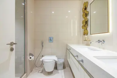 a bathroom with a toilet and a sink and a shower at Sea View 2BR Apartment in Beach Vista 2 in Dubai