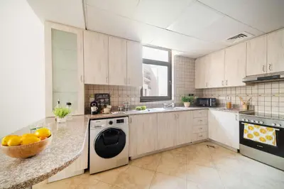a kitchen with a washer and a dishwasher at Cozy 1BR in the Peaceful Community of Motor City in Dubai