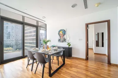 a dining room with a table and chairs at Lavish 2BR - Study with Spacious Balcony in DIFC in Dubai