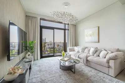 a living room with a couch and a tv at Frank Porter - Creek Crescent Tower 1 in Dubai