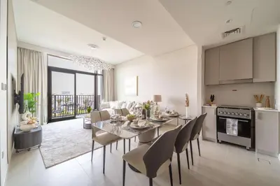 a kitchen and dining room with a table and chairs at Frank Porter - Creek Crescent Tower 1 in Dubai