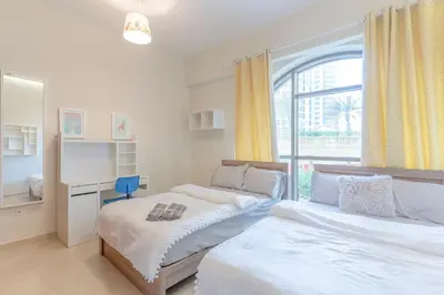 a bedroom with two beds and a window at Seashell stunning 2 bedrooms in JBR in Dubai