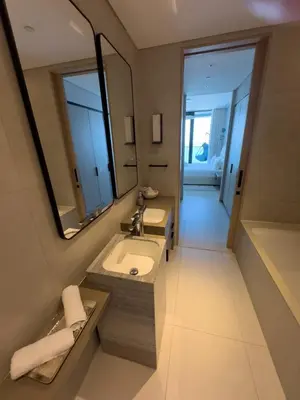 a bathroom with a sink and a mirror and a tub at ADDRESS BEACH RESORT Residence Million Dollar Sea and Palm View DXB AIRPORT VIP Shuttle option in Dubai