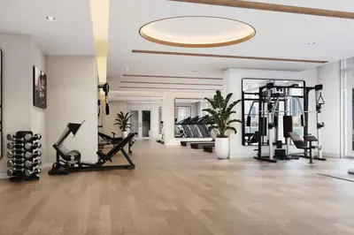 a gym with treadmills and machines in a room at Brand New Stylish 1-Bed Getaway with Private Beach and Palm Views in Dubai
