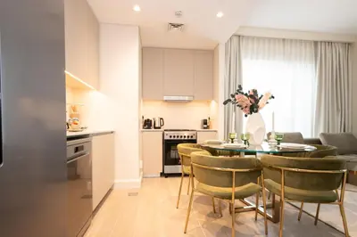 a kitchen and dining room with a table and chairs at Creek New Luxury Stay Beach and Lagoona Access in Dubai