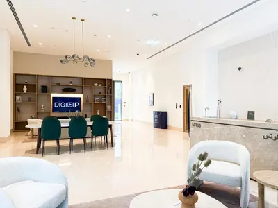 a living room with a table and chairs at Creek New Luxury Stay Beach and Lagoona Access in Dubai