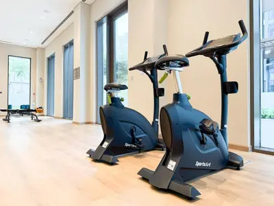two elliptical exercise bikes in a gym at Creek New Luxury Stay Beach and Lagoona Access in Dubai